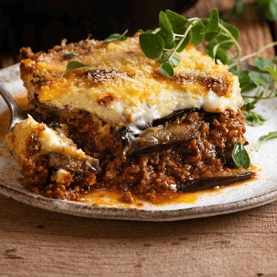 Traditional Greek Moussaka - layered eggplant casserole with béchamel sauce