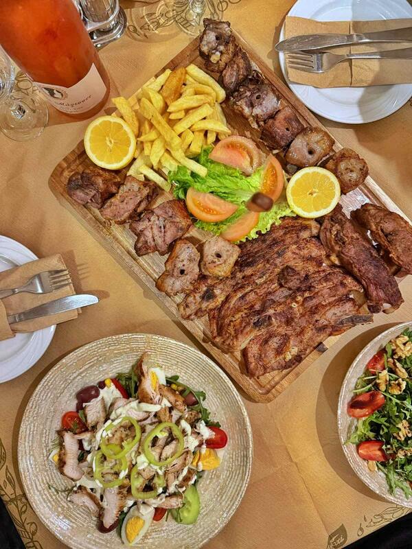 Mixed grill platter with salads and fresh vegetables at Taverna Xarama